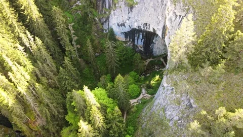 FPV Dive Hikers Exit Cavern Sunset River Nature Stock-Footage 274140081