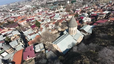 FPV Dive Over Old Tbilisi | Mountain Drop Across Church with City View 库存影片 310843007