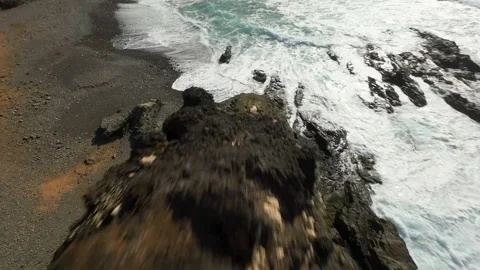 Fpv dive Peña Horadada waves  Fuerteventura drone aerial flying beach Stock Footage 223582199