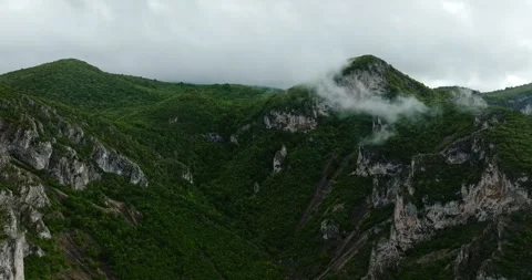 Fpv Dive Towards Cloud Covered Mountain Top Vast Landscape Vapor Tropical Summer Stock Footage 300442180