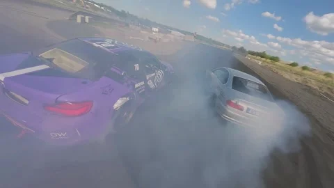 FPV Drift Battle Showcasing Precision Driving in Sunlit Conditions Stock Footage 328178573