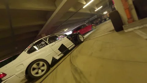 FPV Drift Chase Through Tight Garage Corners Stock Footage 327035517