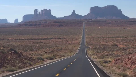 FPV: Driving along the straight empty road towards Monument Valley landmark USA Stock Footage 77618124