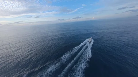 FPV drone aerial of small boat on calm sea coast in Japan at sunset Video stock 331728107