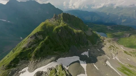 FPV drone on alpine spring mountain range blue lake in canyon Stock Footage 330057087