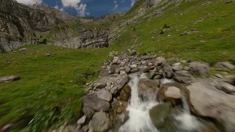FPV Drone Ascent and Dive Along Alpine Stream and Waterfall Stock Footage 312818851