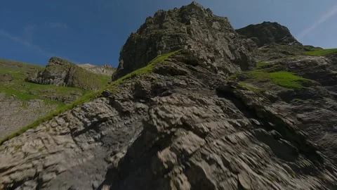 FPV Drone Ascent Over Rugged Alpine Peak in the Swiss Alps Stock Footage 312827547