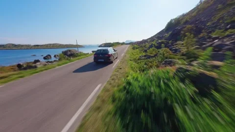FPV Drone Chase Behind Car Driving Through Lofoten Video stock 305803307