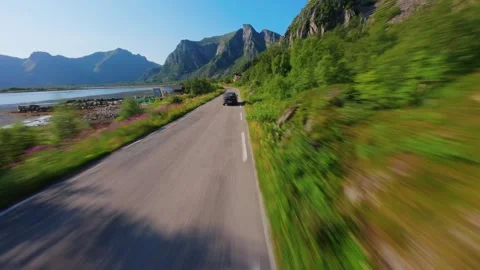 FPV Drone Chase Behind Car Driving Through Lofoten Stock Footage 305803422