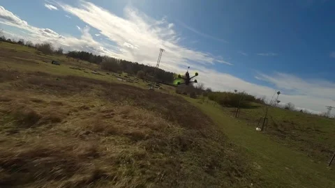 FPV Drone Chase Starting Along Fence, Then Over Open Meadow Stock Footage 313762926