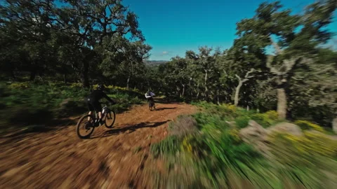 FPV drone chase through forest with bikers Stock Footage 308877325