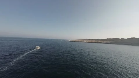 FPV drone chasing a boat in the sea RAW video Stock Footage 248690995