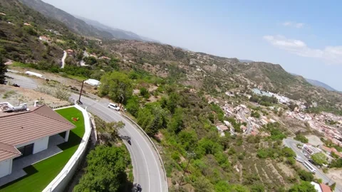 FPV Drone Chasing Four Motorbikes on Winding Mountain Road Stock Footage 313054508