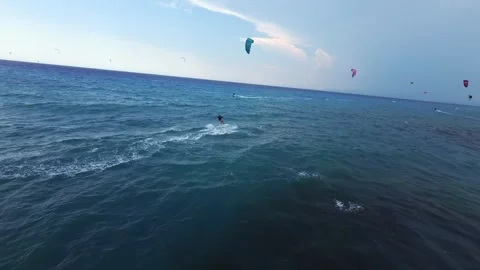 FPV drone chasing kitesurfer riding rough sea in stormy weather Lefkada Greece Stock Footage 329667986