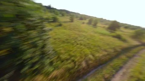 FPV drone chasing a man riding a motocross bike at high speeds. Stock Footage 247128044