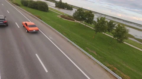 FPV Drone Chasing Musclecar Above The Road Video stock 159404501
