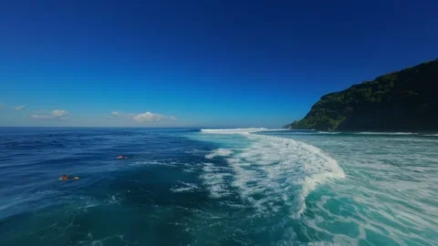 FPV Drone Chasing Ocean Wave With Surfers at Nyang Nyang Beach, High Speed Fligh Stock Footage 336639491