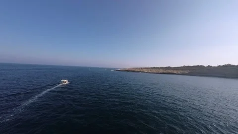 FPV drone chasing a small boat in the sea Stock Footage 248691013