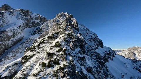 FPV Drone Chasing Snowy Mountain Ridge, 4K Stock Footage 321152657