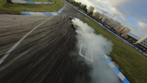 FPV drone chasing two drift cars in competition. Slow motion shot. Vídeos de archivo 169414614