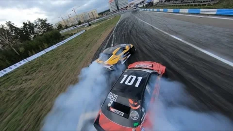 FPV drone chasing two drift cars in competition. Slow motion shot. Vídeos de archivo 169414633