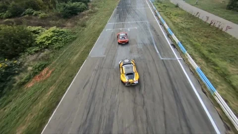 FPV drone chasing two drift cars in competition. Slow motion shot. Vídeos de archivo 169414658