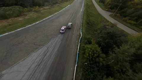 FPV drone chasing two drift cars in competition. Slow motion shot. Vídeos de archivo 169414744