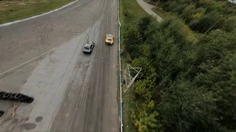 FPV drone chasing two drift cars in competition. Slow motion shot. Vídeos de archivo 169414788