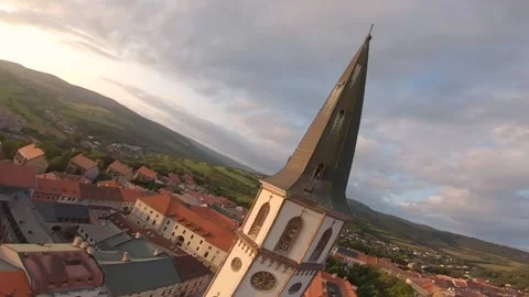 FPV drone cinematic dive around nice church in a small historic city Stock Footage 169280501