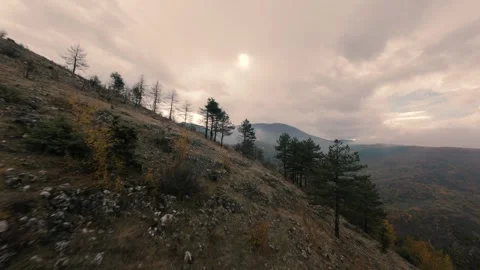 FPV Drone Cinematic Flight Over Autumn Mountain Slope Under Cloudy Sky Stock Footage 328105406