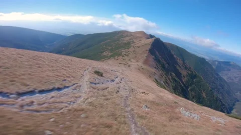 FPV drone cinematic flying close to ground in high mountains in Fall Stock Footage 169280561
