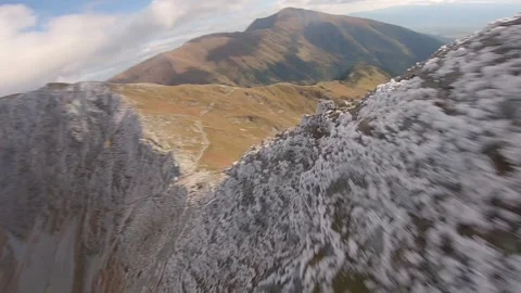 FPV drone cinematic flying close to shapr rocks in high half frozen mountains Stock Footage 169280601