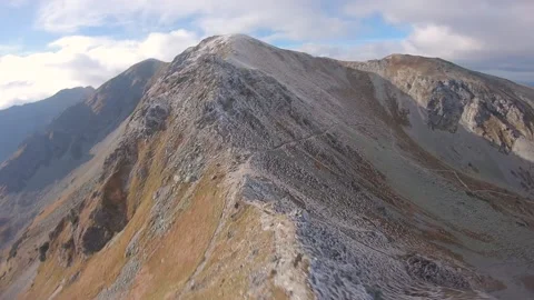 FPV drone cinematic flying really high in half frozen mountains Stock Footage 169280602