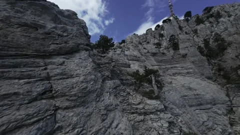 FPV Drone Close Flight Along Rugged Rock Face Stock Footage 309036599