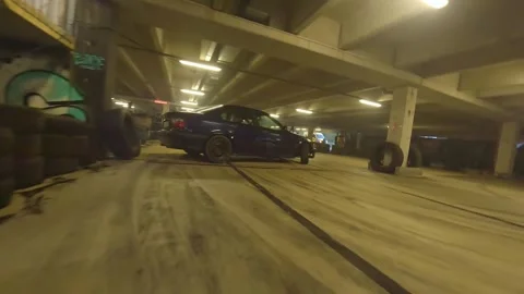 FPV Drone Close-Range Drift: Blue BMW Underground Garage Action Stock Footage 327030552