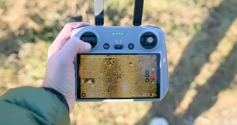 FPV drone controller zooming in on terrain during flight Stock Footage 302882286