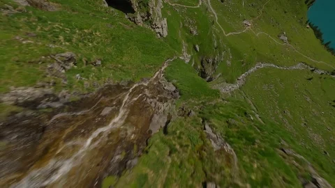 FPV Drone Dive Along Alpine Stream and Waterfall Stock Footage 312818687