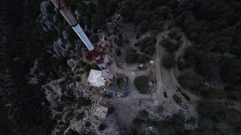 FPV Drone Dive Around Tall Tower in Mountain Landscape Stock Footage 309034830