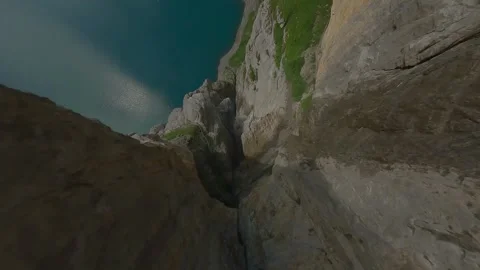 FPV Drone Dive Between Rocky Cliffs Toward Oeschinensee, Switzerland (4K) Stock Footage 312002393