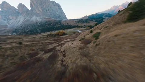FPV Drone Dive Down Alpine Slope After Sunset with Dolomites Peaks Stock Footage 327414874