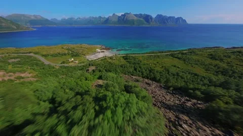 FPV Drone Dive Down Green Mountain Toward Ocean in Lofoten, Norway Stock Footage 305803135