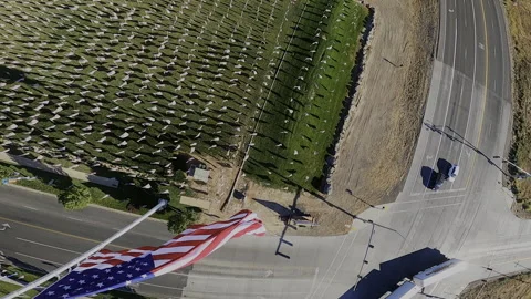 FPV Drone Dive Past American Flag at Half-Staff - Memorial Field Aerial Stock Footage 332025889