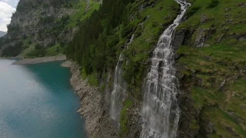 FPV Drone Dive in Slow Motion Along Alpine Waterfall Stock Footage 312409901