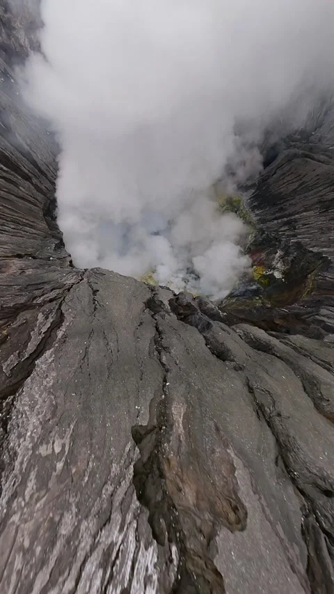 FPV drone dive into steaming Bromo volcanic crater in East Java, Indonesia. Stock Footage 317504041