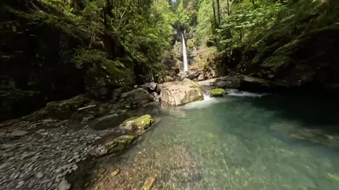 FPV Drone Dive into Waterfall in Green Forest, Cinematic Low Flight Approach Video stock 336251093