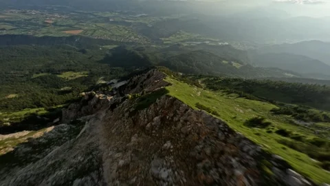 FPV Drone Dive Weaving Between Green Rocky Peaks in Summer, 4K Stock Footage 321200378