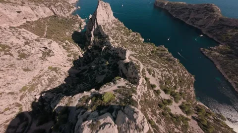 FPV drone diving down cliff towards the sea near Montpellier France Stock Footage 330987944