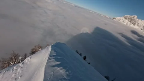FPV Drone Diving Into Misty Valley Snow Covered Alps, 4K Stock Footage 323465566