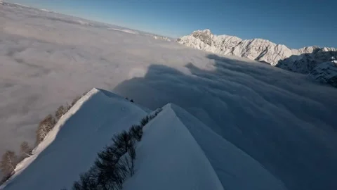 FPV Drone Diving Into Misty Valley Ridge Surfing Snow Covered Alps, 4K Stock Footage 323465583