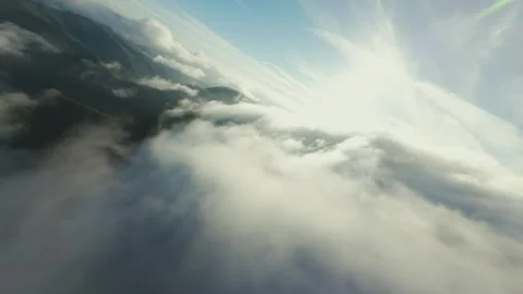 FPV Drone Diving Through Moving Clouds Over Coastal City and Mountains Stock-Footage 319415372